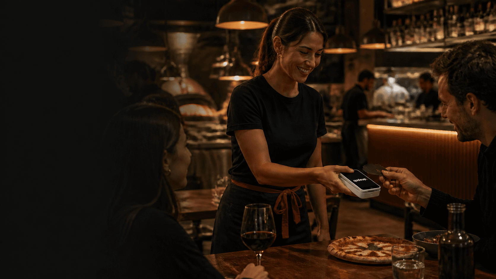 Restaurant staff taking payment with the Qodeup Payment Terminal
